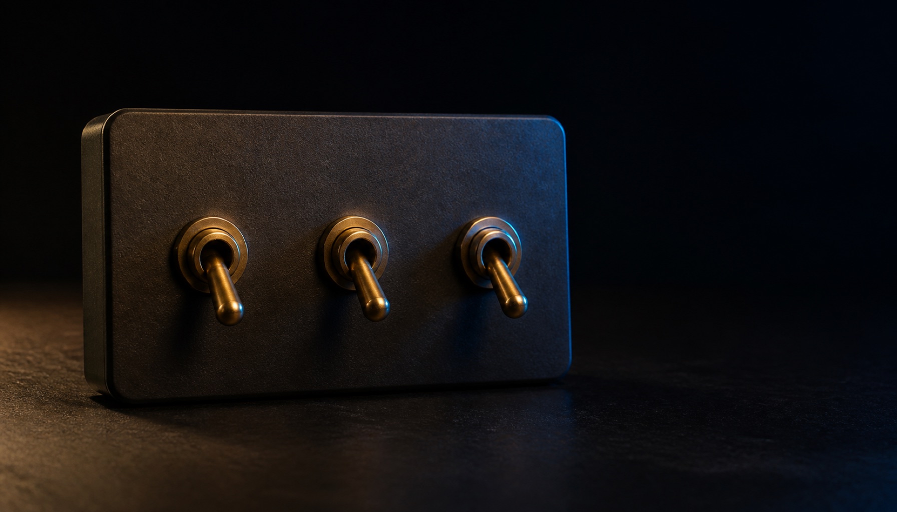 Three brass toggle switches mounted in a row on a dark steel panel, lit in sequence from left to right